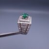 Studio close-up photograph of a handcrafted size 23 men's 925 sterling silver ring centered with a 1.60 carat oval emerald framed by a double rectangular tier of pavé-set natural diamonds.