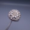 Studio close-up photograph of a handcrafted size 17 men's 925 sterling silver cluster ring featuring a circular face with a geometric star design completely pavé-set with sparkling natural diamonds.