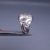 Studio close-up photograph of a handcrafted size 17 men's 925 sterling silver cluster ring featuring a circular face with a geometric star design completely pavé-set with sparkling natural diamonds.