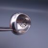 Studio close-up photograph of a handcrafted size 17 men's 925 sterling silver cluster ring featuring a circular face with a geometric star design completely pavé-set with sparkling natural diamonds.