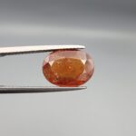 Natural honey-orange Hessonite Garnet Gomed oval faceted gemstone 5.27 carat with visible inclusions