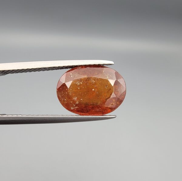 Natural honey-orange Hessonite Garnet Gomed oval faceted gemstone 5.27 carat with visible inclusions