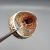 Studio close-up photographs showing the top and side profile views of a handcrafted 925 sterling silver ring featuring a natural Italian coral center stone and matching coral side accents.