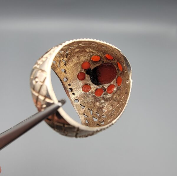 Studio close-up photographs showing the top and side profile views of a handcrafted 925 sterling silver ring featuring a natural Italian coral center stone and matching coral side accents.