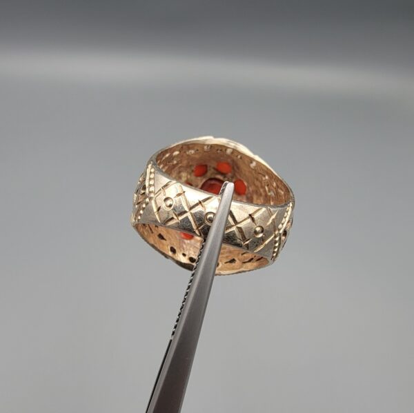 Studio close-up photographs showing the top and side profile views of a handcrafted 925 sterling silver ring featuring a natural Italian coral center stone and matching coral side accents.