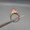 Studio close-up photographs showing the top and side profile views of a handcrafted 925 sterling silver ring featuring a natural Italian coral center stone and matching coral side accents.