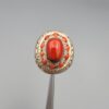 Studio close-up photographs showing the top and side profile views of a handcrafted size 22 solid 925 sterling silver ring featuring a natural Italian coral center stone and matching coral side accents.