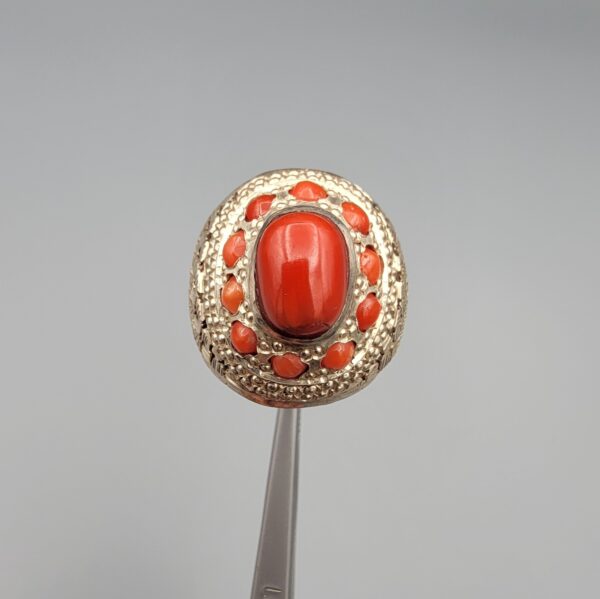 Studio close-up photographs showing the top and side profile views of a handcrafted size 22 solid 925 sterling silver ring featuring a natural Italian coral center stone and matching coral side accents.