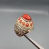 Studio close-up photographs showing the top and side profile views of a handcrafted size 22 solid 925 sterling silver ring featuring a natural Italian coral center stone and matching coral side accents.
