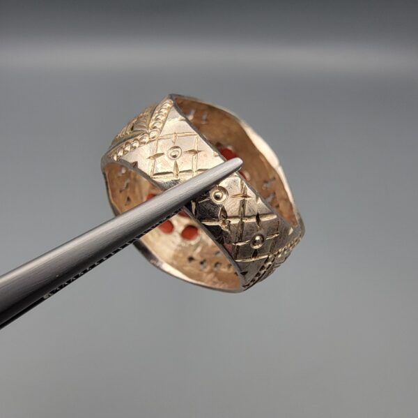 Studio close-up photographs showing the top and side profile views of a handcrafted size 22 solid 925 sterling silver ring featuring a natural Italian coral center stone and matching coral side accents.