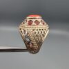 Studio close-up photographs showing the top and side profile views of a handcrafted size 23 solid 925 sterling silver ring featuring a natural Italian coral center stone surrounded by faceted garnet accent stones.