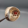 Studio close-up photographs showing the top and side profile views of a handcrafted size 23 solid 925 sterling silver ring featuring a natural Italian coral center stone surrounded by faceted garnet accent stones.