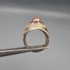 Studio close-up photographs showing the top and side profile views of a handcrafted size 23 solid 925 sterling silver ring featuring a natural Italian coral center stone surrounded by faceted garnet accent stones.