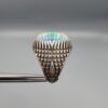 Studio close-up photographs showing the top and detailed side shank views of a 10+ carat natural Ethiopian opal ring crafted in solid sterling silver with an intricate Turkish design.