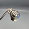 Studio close-up photographs showing the top and detailed side shank views of a 10+ carat natural Ethiopian opal ring crafted in solid sterling silver with an intricate Turkish design.