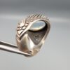 Studio close-up photographs showing the top and detailed side shank views of a 10+ carat natural Ethiopian opal ring crafted in solid sterling silver with an intricate Turkish design.