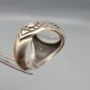 Studio close-up photographs showing the top and detailed side shank views of a 10+ carat natural Ethiopian opal ring crafted in solid sterling silver with an intricate Turkish design.
