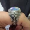 Studio close-up photographs showing the top and detailed side shank views of a 10+ carat natural Ethiopian opal ring crafted in solid sterling silver with an intricate Turkish design.
