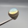 Studio close-up photographs showing the top and detailed side shank views of a 10+ carat natural Ethiopian opal ring crafted in solid sterling silver with an intricate Turkish design.