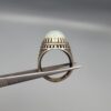Studio close-up photographs showing the top and detailed side shank views of a 10+ carat natural Ethiopian opal ring crafted in solid sterling silver with an intricate Turkish design.