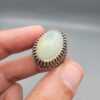 Studio close-up photographs showing the top and detailed side shank views of a 10+ carat natural Ethiopian opal ring crafted in solid sterling silver with an intricate Turkish design.