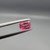 Studio close-up photographs showing the top and facet profile views of a 0.63 carat cushion mixed cut natural rubellite tourmaline loose gemstone held in tweezers.