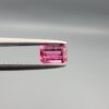 Studio close-up photographs showing the top and facet profile views of a 0.52 carat octagon cut natural rubellite tourmaline loose gemstone held in precision tweezers.
