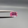 Studio close-up photographs showing the top and facet profile views of a 0.75 carat octagon cut natural rubellite tourmaline loose gemstone held in precision tweezers.