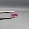 Studio close-up photographs showing the top and facet profile views of a 0.75 carat octagon cut natural rubellite tourmaline loose gemstone held in precision tweezers.