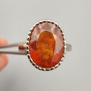 Studio close-up photographs showing the top oval face, 925 stamp, 6.12 weight hallmark, and side profile settings of a natural hessonite gomed sterling silver ring.