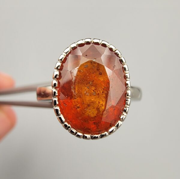 Studio close-up photographs showing the top oval face, 925 stamp, 6.12 weight hallmark, and side profile settings of a natural hessonite gomed sterling silver ring.