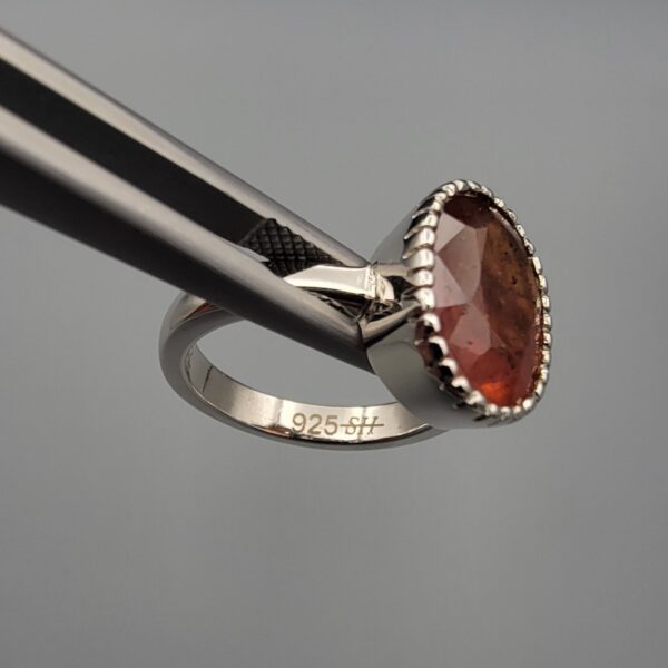 Studio close-up photographs showing the top oval face, 925 stamp, 6.12 weight hallmark, and side profile settings of a natural hessonite gomed sterling silver ring.