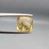 Studio close-up photographs showing the high-brilliance facet pattern, luminous golden body, and striking untreated internal rainbow light reflections of a 2.98 carat cushion cut natural citrine quartz loose gemstone held in precision tweezers.