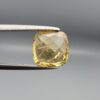 Studio close-up photographs showing the high-brilliance facet pattern, warm golden body, and striking natural internal needle crystal inclusions of a 2.93 carat cushion cut natural citrine quartz loose gemstone held in precision tweezers.
