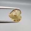 Studio close-up photographs showing the high-brilliance facet pattern, romantic heart outline, luminous golden body, and striking sparkling untreated internal crystal inclusions of a 5.68 carat heart shape natural citrine quartz loose gemstone held in precision tweezers.