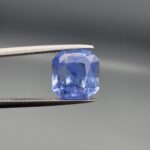 Official GRA Gemological Identification Report displaying the certification details and a photograph of an 8.04 carat, octagon-cut natural unheated pastel blue sapphire gemstone from Sri Lanka.