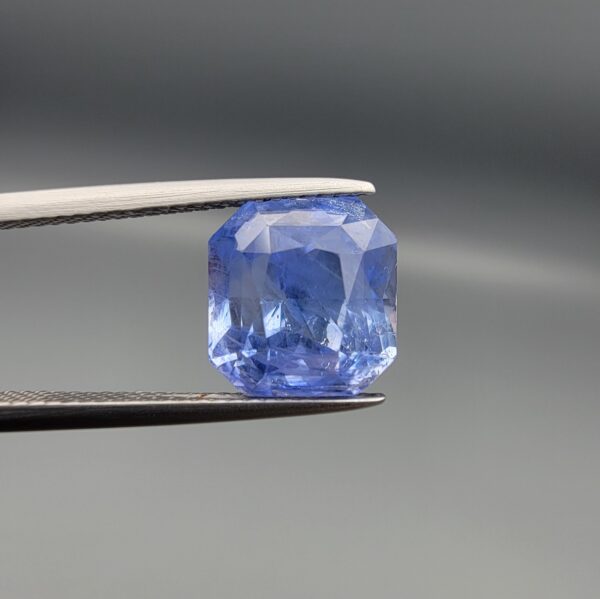 Official GRA Gemological Identification Report displaying the certification details and a photograph of an 8.04 carat, octagon-cut natural unheated pastel blue sapphire gemstone from Sri Lanka.