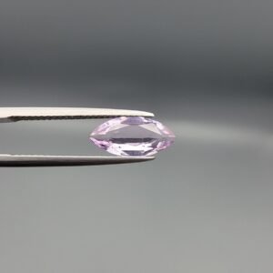 Studio close-up photographs displaying a 1.68-carat marquise-cut natural amethyst Katela gemstone held securely in precision tweezers against a neutral grey background.