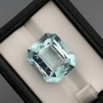 Digital image of a Gemstone Report from The Gemstone Company (Report # TGC-20260828-4529) dated August 28, 2026, signed by GIA Graduate Gemologist Muhammad Momin. It details a 22.34 Carat Octagonal Mixed Cut Natural Aquamarine with transparent greenish-blue color.
