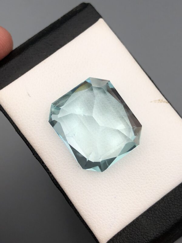 Digital image of a Gemstone Report from The Gemstone Company (Report # TGC-20260828-4529) dated August 28, 2026, signed by GIA Graduate Gemologist Muhammad Momin. It details a 22.34 Carat Octagonal Mixed Cut Natural Aquamarine with transparent greenish-blue color.