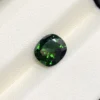 High-resolution scan of an official GGI (Galaxy Gemological Institute) Gemstone Report for a 1.48-carat Natural Chrome Green Tourmaline sourced from Tanzania, detailed with certificate number KHI2610280448, cushion mixed cut dimensions (7.77 x 6.94 x 4.33 mm), transparent green color, and QR verification code.