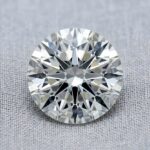 Official GIA Natural Diamond Dossier scan for a 0.61-carat round brilliant loose diamond, detailing report number 1318972900, G color grade, SI2 clarity grade, Excellent cut grade, Excellent polish, Excellent symmetry, None fluorescence, and laser inscription GIA 1318972900.