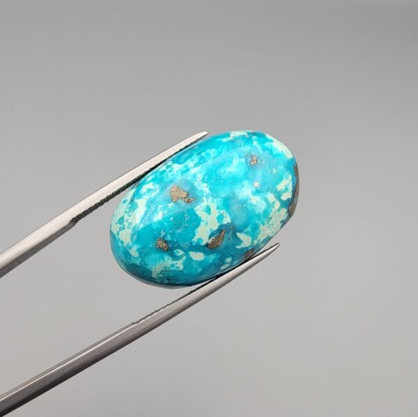 Natural Sky-Blue Turquoise (Feroza) – Weight 33.41 Carat – Origin Kerman (Iran) – Oval Shape with White Host Rock and Pyrite Clustered Backing