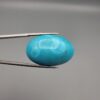 Magnificent 53.10 carat natural vibrant sky-blue Sleeping Beauty turquoise (Razaki Feroza) from Kerman, Iran, styled into an oval cabochon featuring a rich textured finish and an organic mottled host matrix reverse.