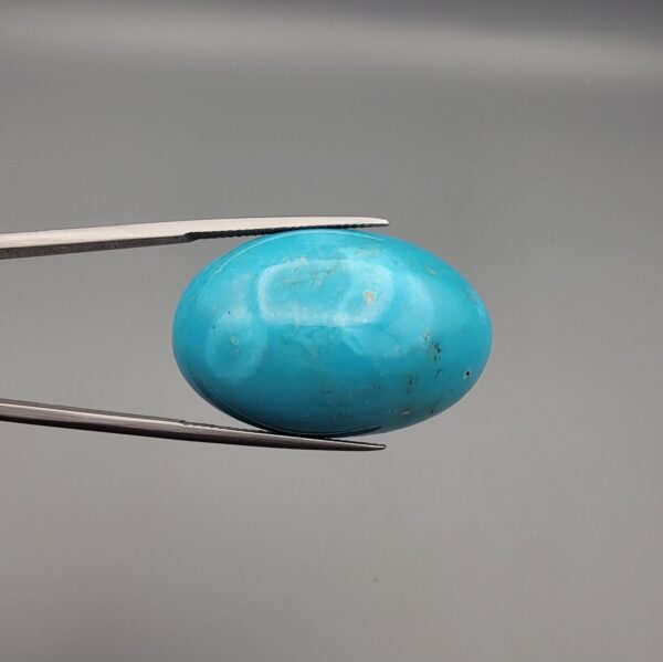Magnificent 53.10 carat natural vibrant sky-blue Sleeping Beauty turquoise (Razaki Feroza) from Kerman, Iran, styled into an oval cabochon featuring a rich textured finish and an organic mottled host matrix reverse.