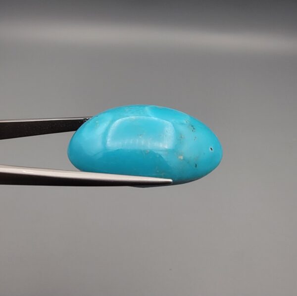 Magnificent 53.10 carat natural vibrant sky-blue Sleeping Beauty turquoise (Razaki Feroza) from Kerman, Iran, styled into an oval cabochon featuring a rich textured finish and an organic mottled host matrix reverse.