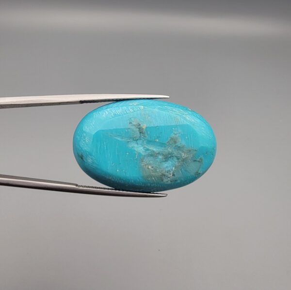 Magnificent 53.10 carat natural vibrant sky-blue Sleeping Beauty turquoise (Razaki Feroza) from Kerman, Iran, styled into an oval cabochon featuring a rich textured finish and an organic mottled host matrix reverse.