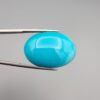 Multi-angle macro photographs of a 32-carat natural vibrant sky-blue Sleeping Beauty turquoise (Razaki Feroza) oval cabochon held in tweezers, featuring a smooth domed front face with subtle natural variations and a reverse side displaying an authentic dark matrix.