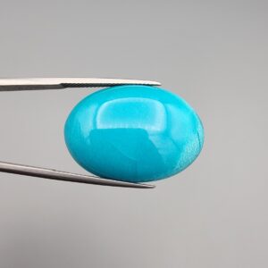 Multi-angle macro photographs of a 32-carat natural vibrant sky-blue Sleeping Beauty turquoise (Razaki Feroza) oval cabochon held in tweezers, featuring a smooth domed front face with subtle natural variations and a reverse side displaying an authentic dark matrix.