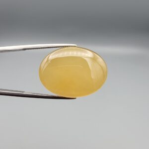 Multi-angle macro photographs of a 32.04-carat natural yellow chalcedony agate (Zard Aqeeq) oval cabochon from Iran held in metal tweezers, showcasing a smooth, domed profile, uniform honey-yellow translucency, and a high-gloss reflective surface.